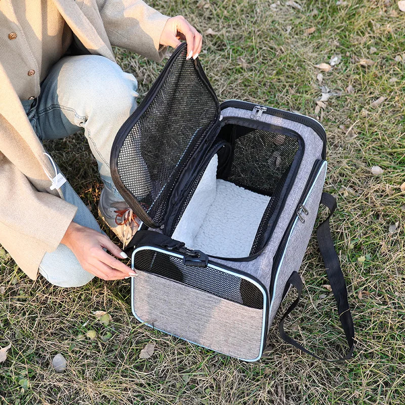 Foldable Showlu Fashion pet carrier bag for cats, portable travel bag with mesh sides and comfortable handles for easy transport.