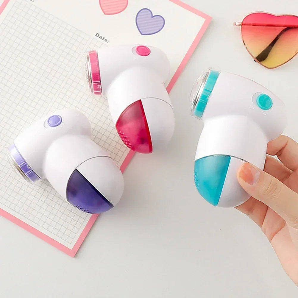 Showlu Smart General electric lint remover fabric shaver with a handheld design and stainless steel blades for removing lint and fuzz from fabrics.