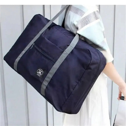 Red, navy, and green Showlu Fashion multifunctional folding travel bag with large capacity, waterproof design, single shoulder strap.