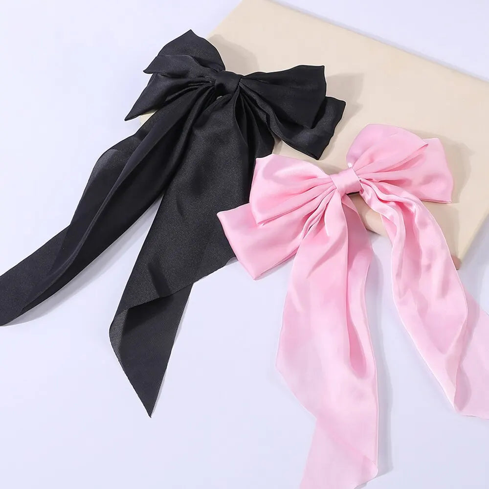 Set of two elegant satin bow ribbon hair clips for women, girls, and ponytails, featuring solid bowknot design and fashionable hair accessories.