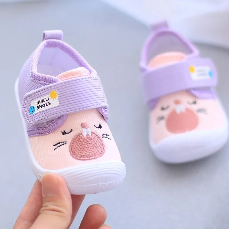 Showlu Fashion baby cartoon squeaky shoes with non-slip canvas soles, designed as first walkers for toddlers.