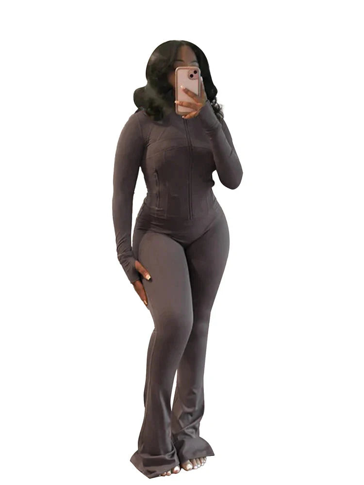 JENYAGE Women's two-piece tracksuit with flared pants and zip-up top, stylish athletic wear in black and white.