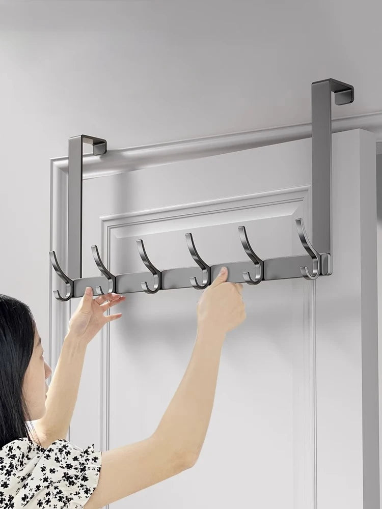 Wall-mounted multi hooks by Showlu Smart General, black metal hooks on a wooden wall for organizing keys and accessories.