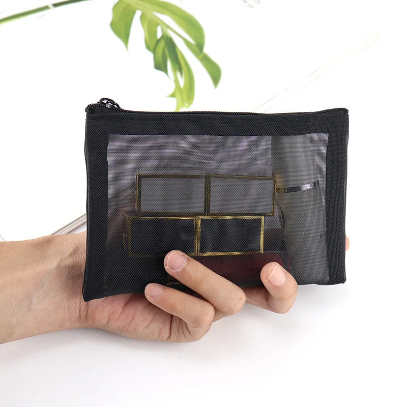 Large black portable outdoor travel makeup bag with transparent mesh compartments for storage and organization.