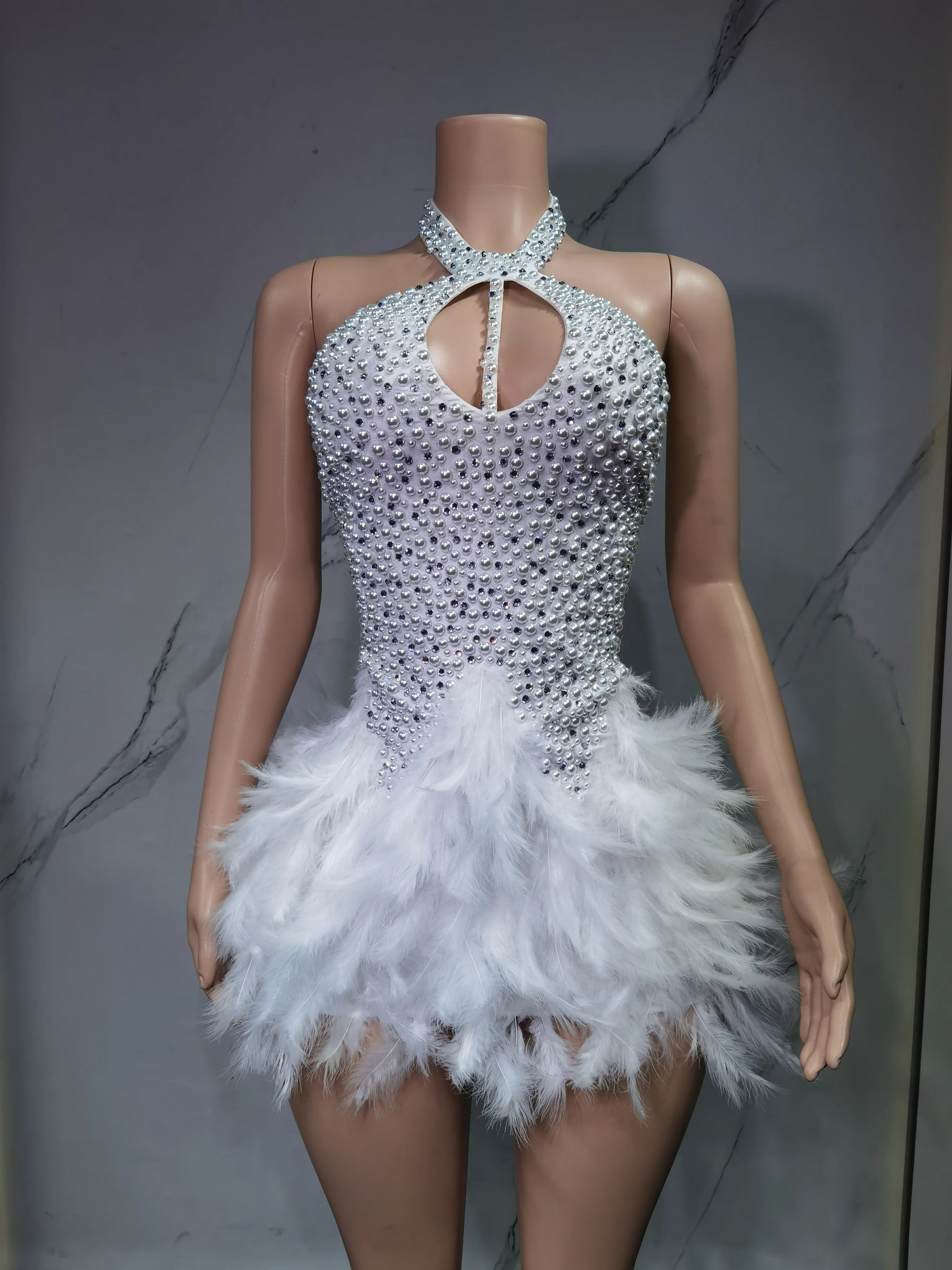 Sexy Latin dance dress by Showlu Fashion Store featuring airy hollow design and feather skirt with hanging neck detail.