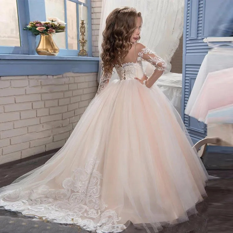 Light pink flower girl dress by Showlu Fashion with tulle, white appliques, long sleeves, perfect for weddings, birthdays, or communions.