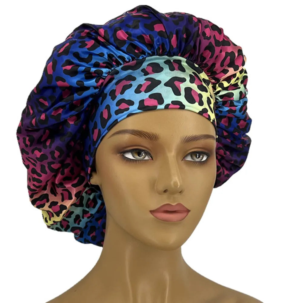 Leopard print women's sleep bonnet with wide elastic band, soft fabric, curl-enhancing cap for dry and textured hair.