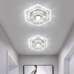 Two modern crystal flower-shaped LED ceiling lights installed in a white hallway.