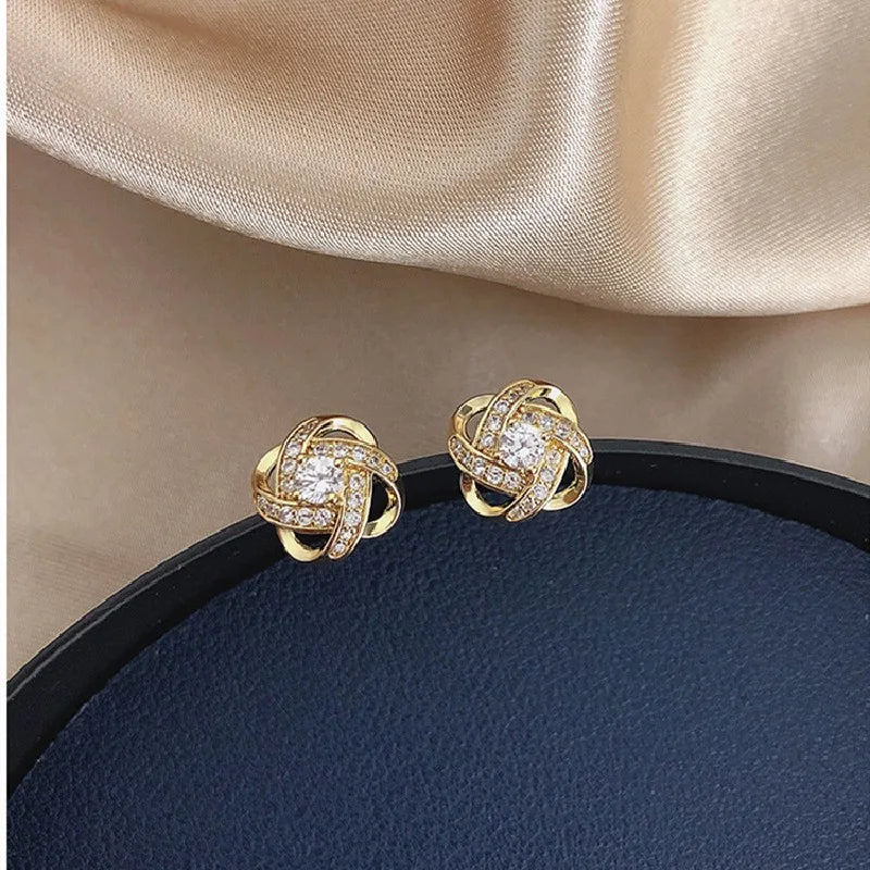 Showlu Fashion zircon cross stud earrings with geometric copper design, showcasing elegant jewelry for pierced ears.