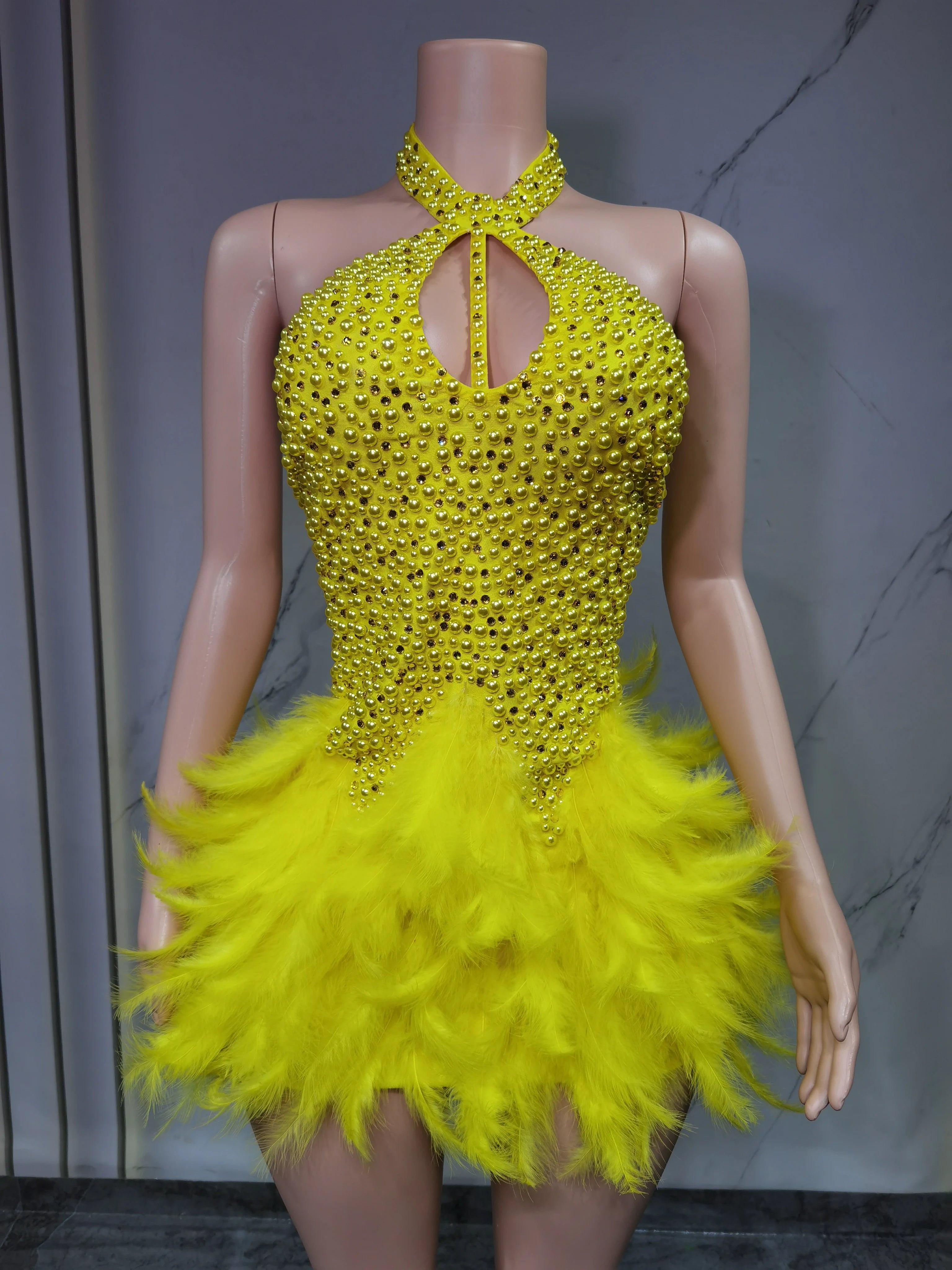 Sexy Latin dance dress by Showlu Fashion with airy hollow design and feather skirt hanging neck for stylish movement.