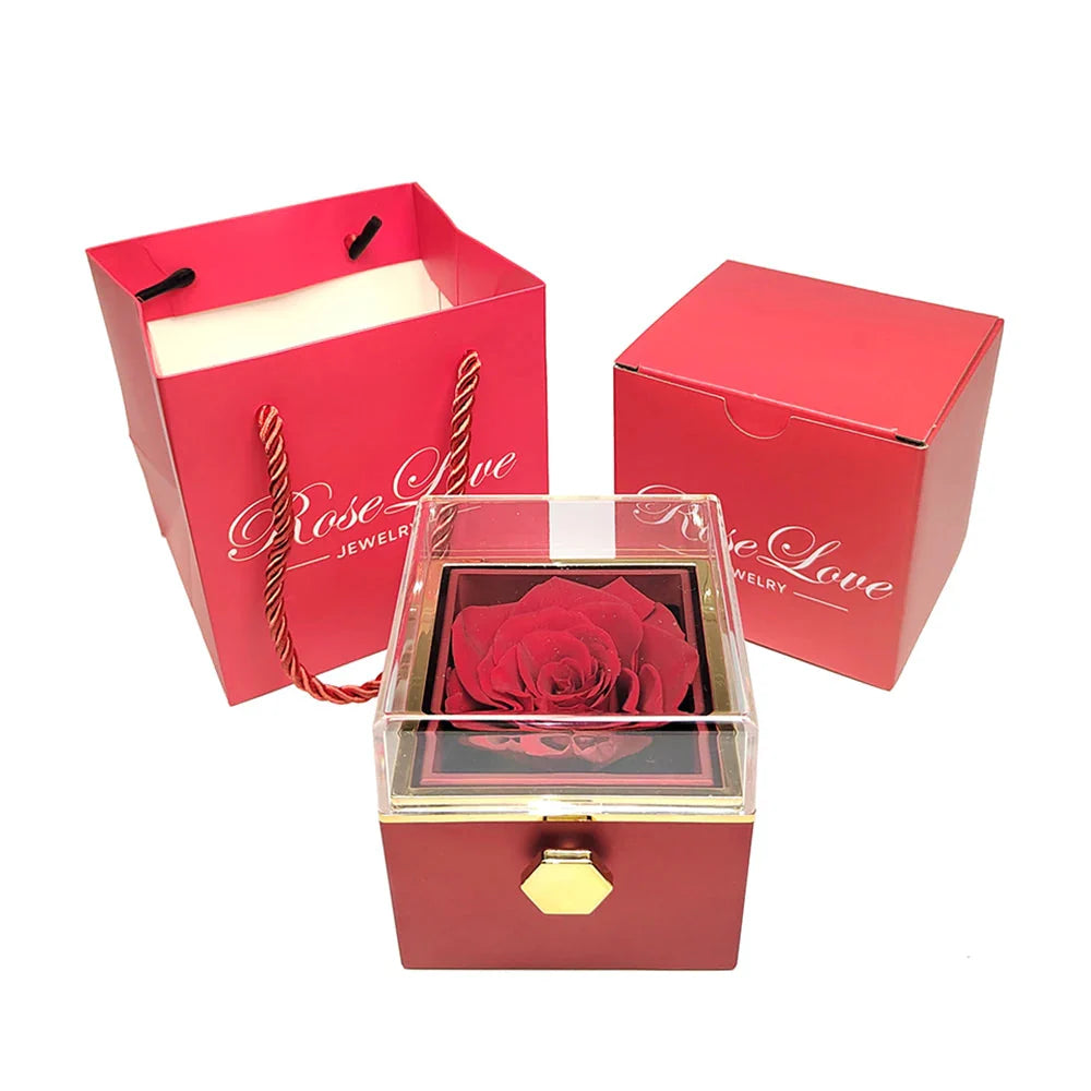 Showlu Fashion engraved interlocking heart necklace with eternal rose in a decorative box, showcasing elegant jewelry and floral display.