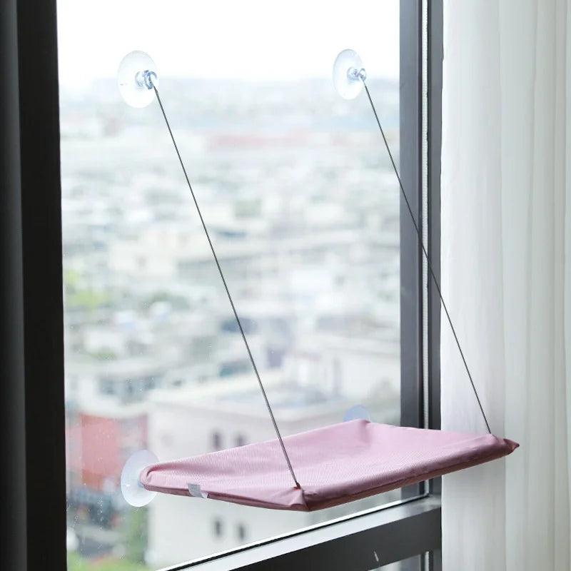 Showlu Smart General cat window hammock hanging on a window, providing a cozy perch for cats to relax and enjoy the view.