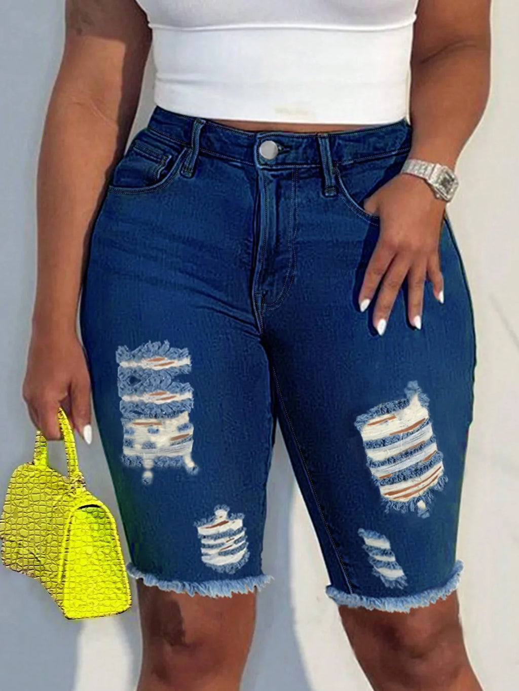 Slim-fit women's denim Bermuda shorts with ripped frayed hem, dark wash, and casual style by SHOWLU FASHION STORE.