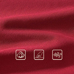 Close-up of red cotton fabric with three icons indicating soft, breathable material.