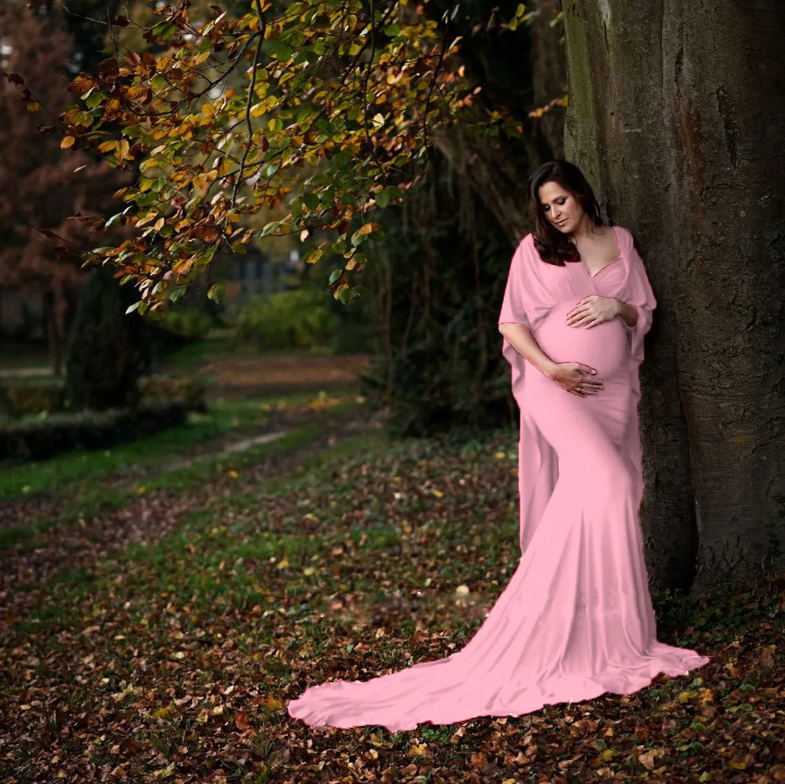 Elegant SHOWLU maternity maxi dress with batwing sleeves, perfect for photoshoots, featuring flowing fabric and a graceful silhouette.