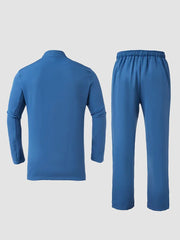 A blue men's two-piece set featuring a long-sleeve round-neck top and matching drawstring pants.