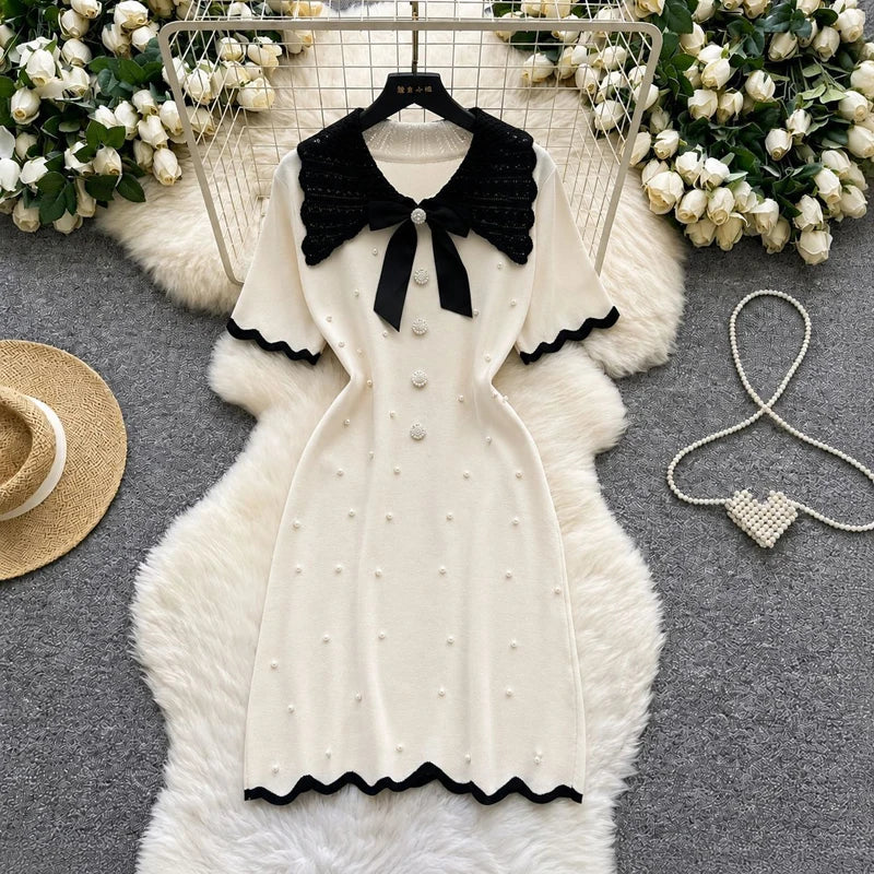 Elegant 2026 summer women's pearl dress by Showlu Smart General, featuring a bow collar, short sleeves, and bodycon fit.