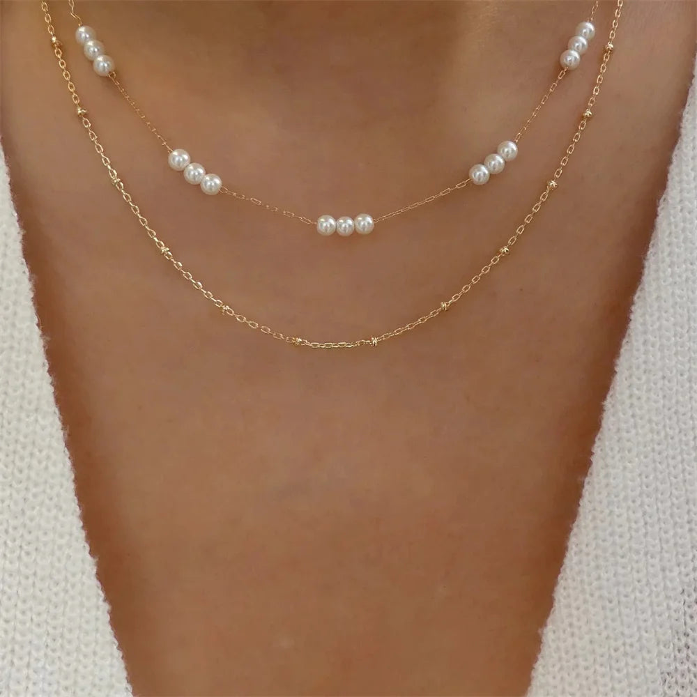 Elegant vintage pearl pendant necklace for women featuring gold multi-layer chain choker with round pendant jewelry.