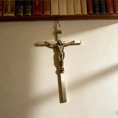 A metal wall crucifix featuring a figure of Jesus Christ with an INRI plaque.