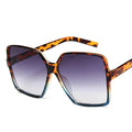 Oversize women's sunglasses with gradient plastic lenses, UV400 protection, stylish design, and brand logo from Showlu Fashion.
