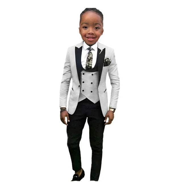 SHOWLU boys formal suit set with cotton tuxedo, includes jacket, vest, and pants, featuring a peak lapel for weddings and special occasions.