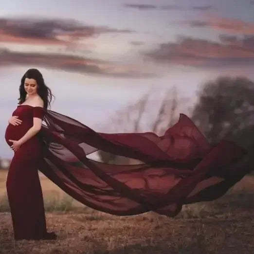 Off-shoulder maternity dress in fluttering fabric, designed for pregnancy photoshoots, by Showlu Fashion Store.