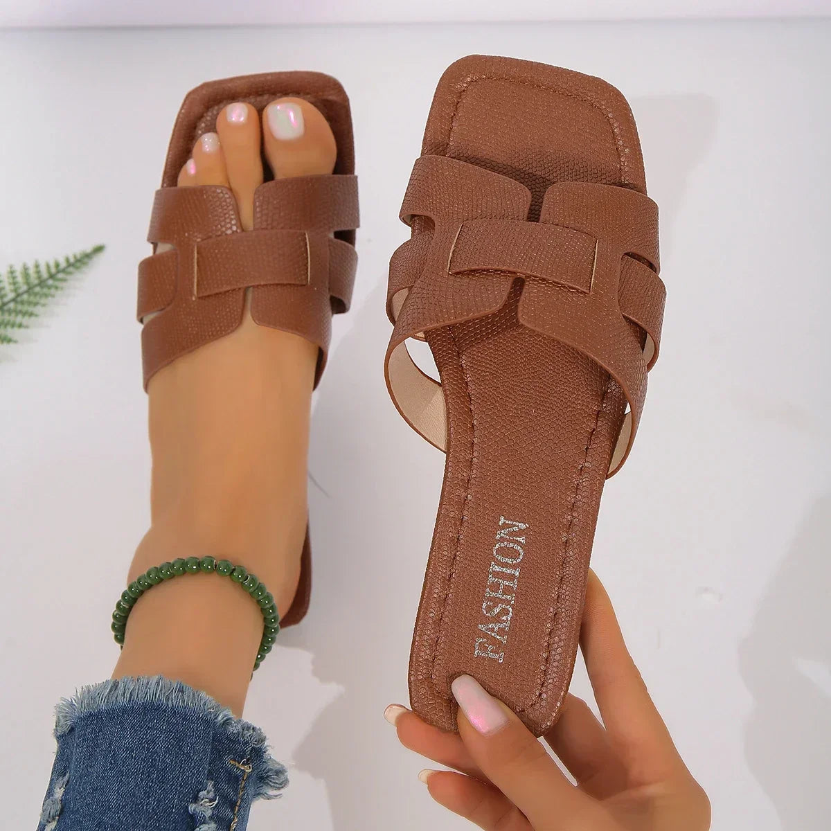 SHOWLU FASHION Women's flat gladiator sandals with multiple straps, perfect for casual summer wear, shown on a model's feet.