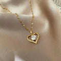 Heart-shaped pendant necklace in hollow zinc alloy, stylish party jewelry with elegant design by ZHIXUN, displayed on a jewelry stand.
