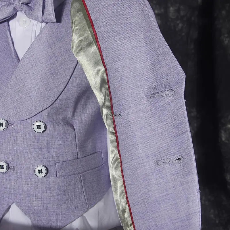Boy in purple formal wedding suit with five-piece tuxedo set, including jacket, vest, pants, shirt, and bow tie for special occasions.