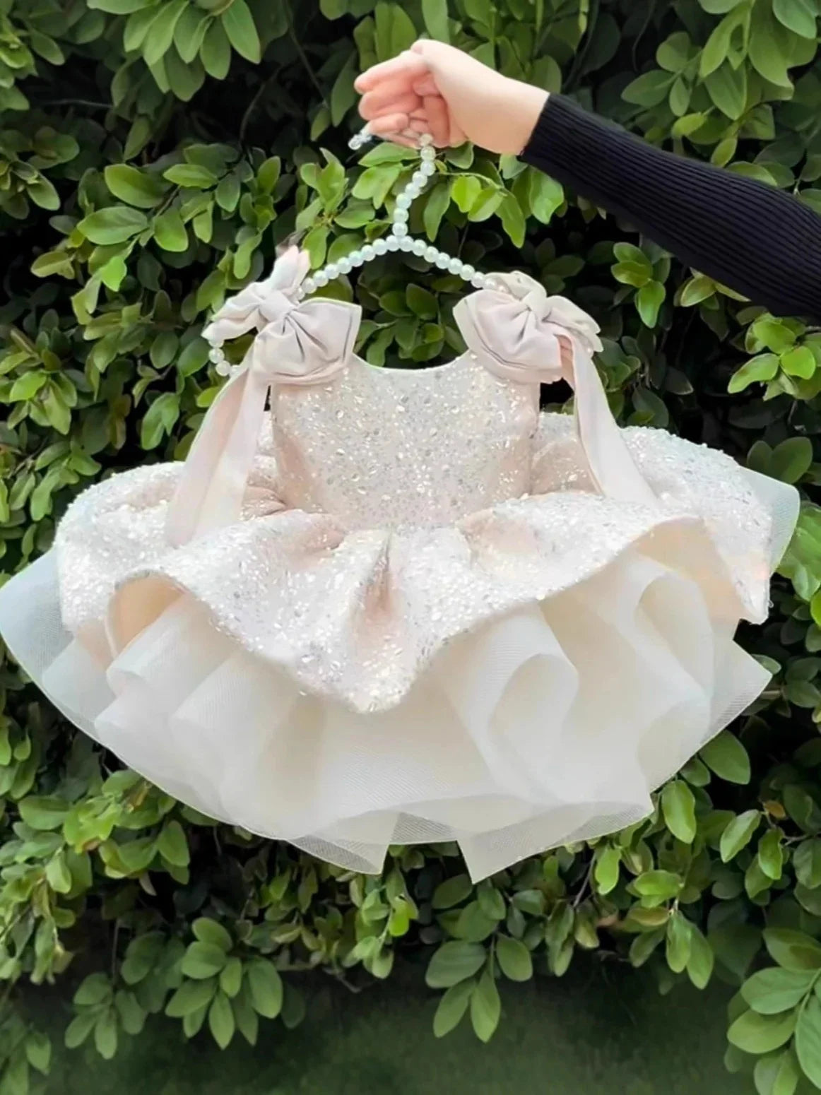 Pink flower girls dress by Showlu Smart General with sleeveless design, bow, sequins, puffy style for weddings and special occasions.