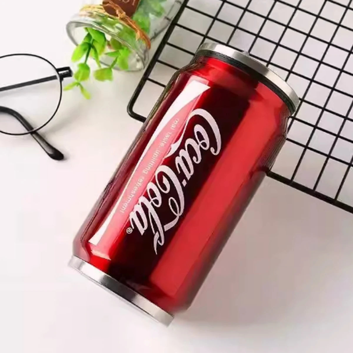 Stainless steel Coca-Cola insulated mug with a sleek design, durable and perfect for keeping drinks hot or cold.