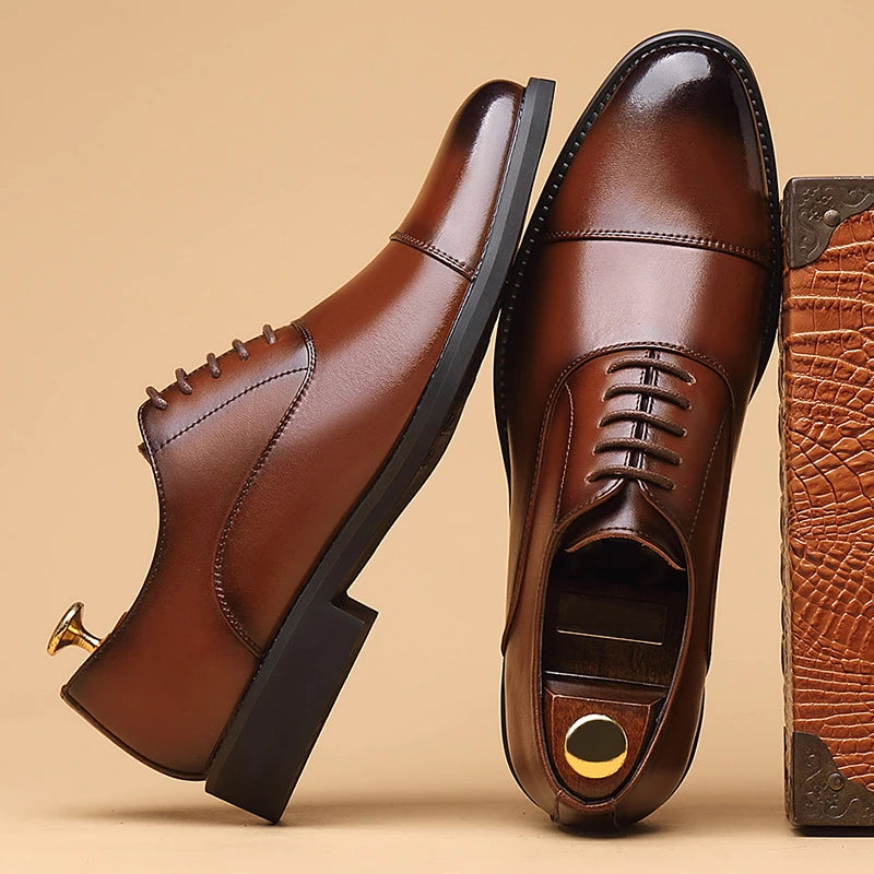 Men's black genuine leather dress shoes with cap toe and lace-up design, suitable for formal office, business, or wedding wear.