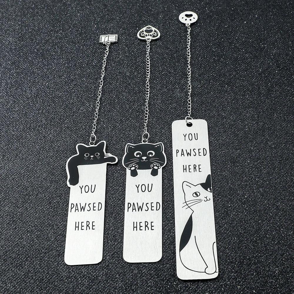 Colorful stainless steel waving cat bookmark with a geometric design, ideal for marking pages in books.