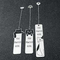 Three stainless steel bookmarks featuring cat designs and the text You Pawsed Here.