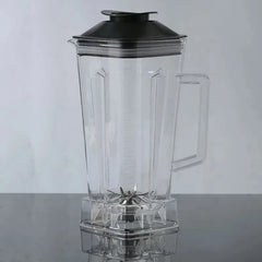 A transparent 2-liter blender replacement jug with a black lid and stainless steel blades.