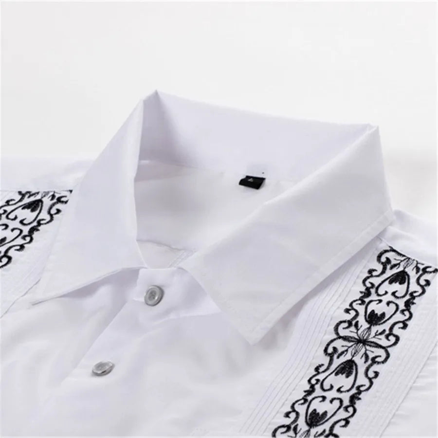 Men's white Guayabera shirt with embroidered Cuban style details, from Showlu Fashion, displayed on a hanger.