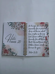 An open spiral-bound prayer journal for women featuring floral designs and John 15:15 text.