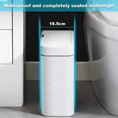 A white, rectangular smart trash can with a sensor lid stands in a bathroom.