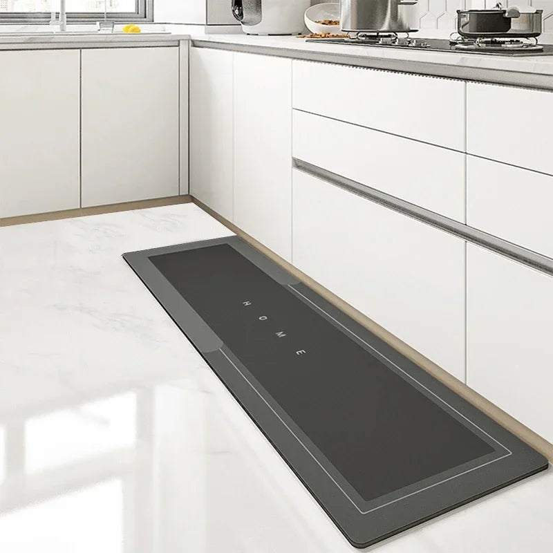 Showlu Fashion super absorbent diatom mud kitchen mat with anti-slip pad, placed on a kitchen floor for safety and moisture absorption.