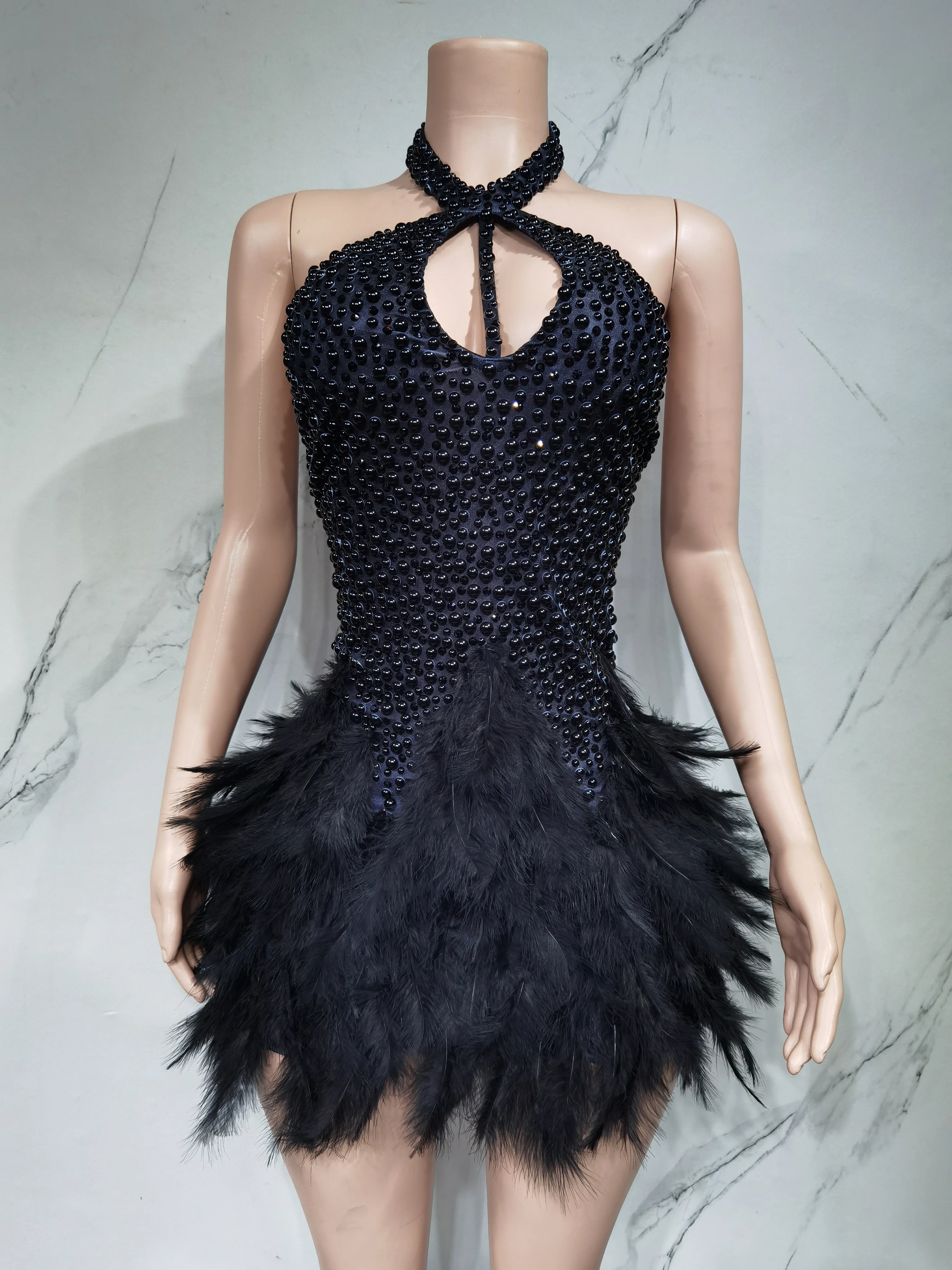 Sexy Latin dance dress with airy hollow design and feather skirt, featuring hanging neck style by Showlu Fashion Store.