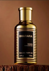 A gold-toned bottle of Bharara King Gold Edition eau de parfum stands on a wooden surface.