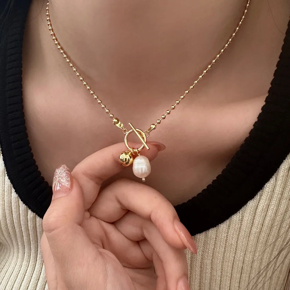 Showlu Fashion stainless steel necklace with freshwater pearl pendant, minimalist OT buckle design, baroque pearl, women's choker style