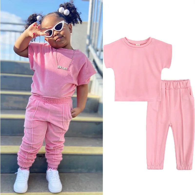 Kids Tales girls' 2-piece cotton T-shirt and pants set, ages 1–6, featuring playful designs and comfortable fabric for young children.