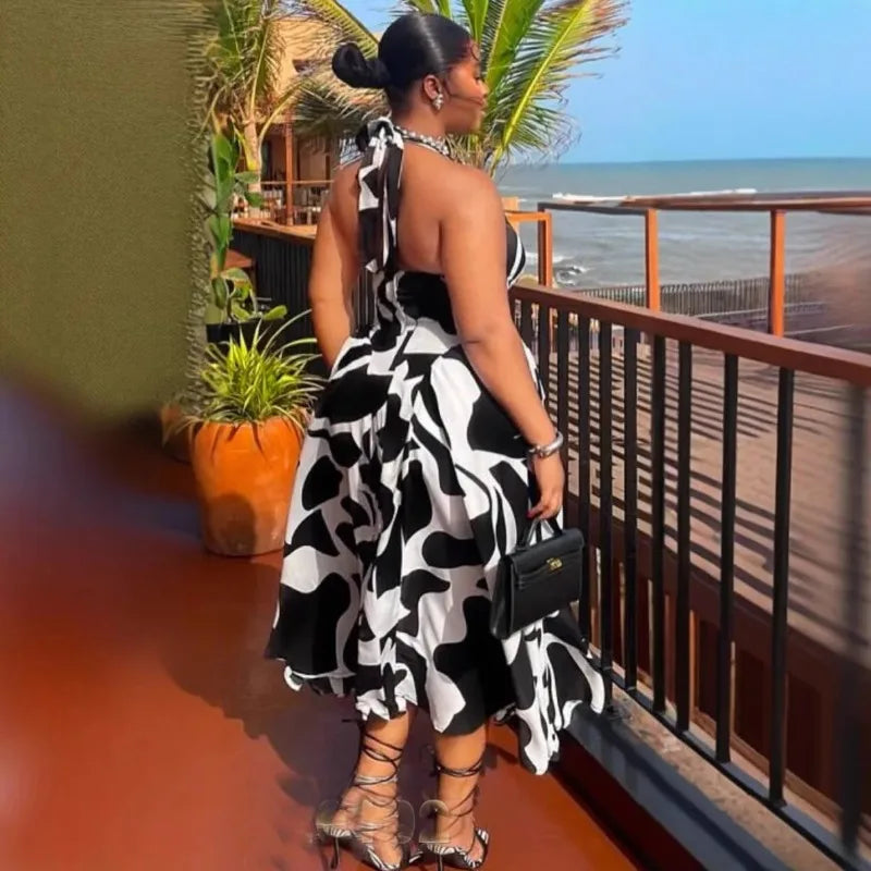 Women’s V-neck sleeveless halter midi dress by Showlu Fashion, backless, printed, perfect for beach, birthday, and party occasions.