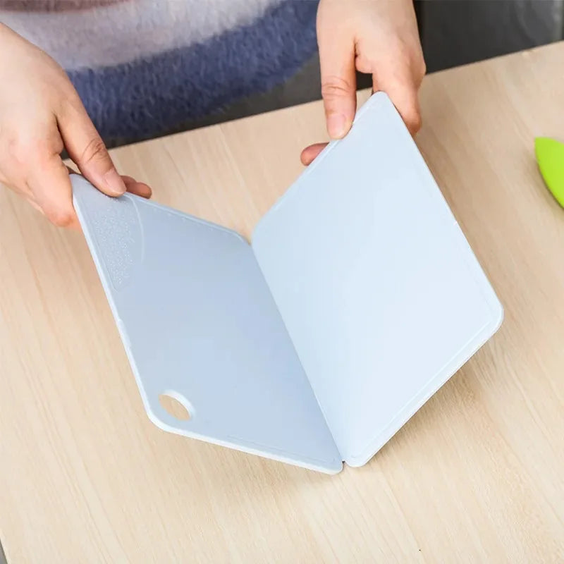 Showlu Smart General collapsible cutting board folded in a kitchen, featuring a compact, space-saving design for easy storage and use.