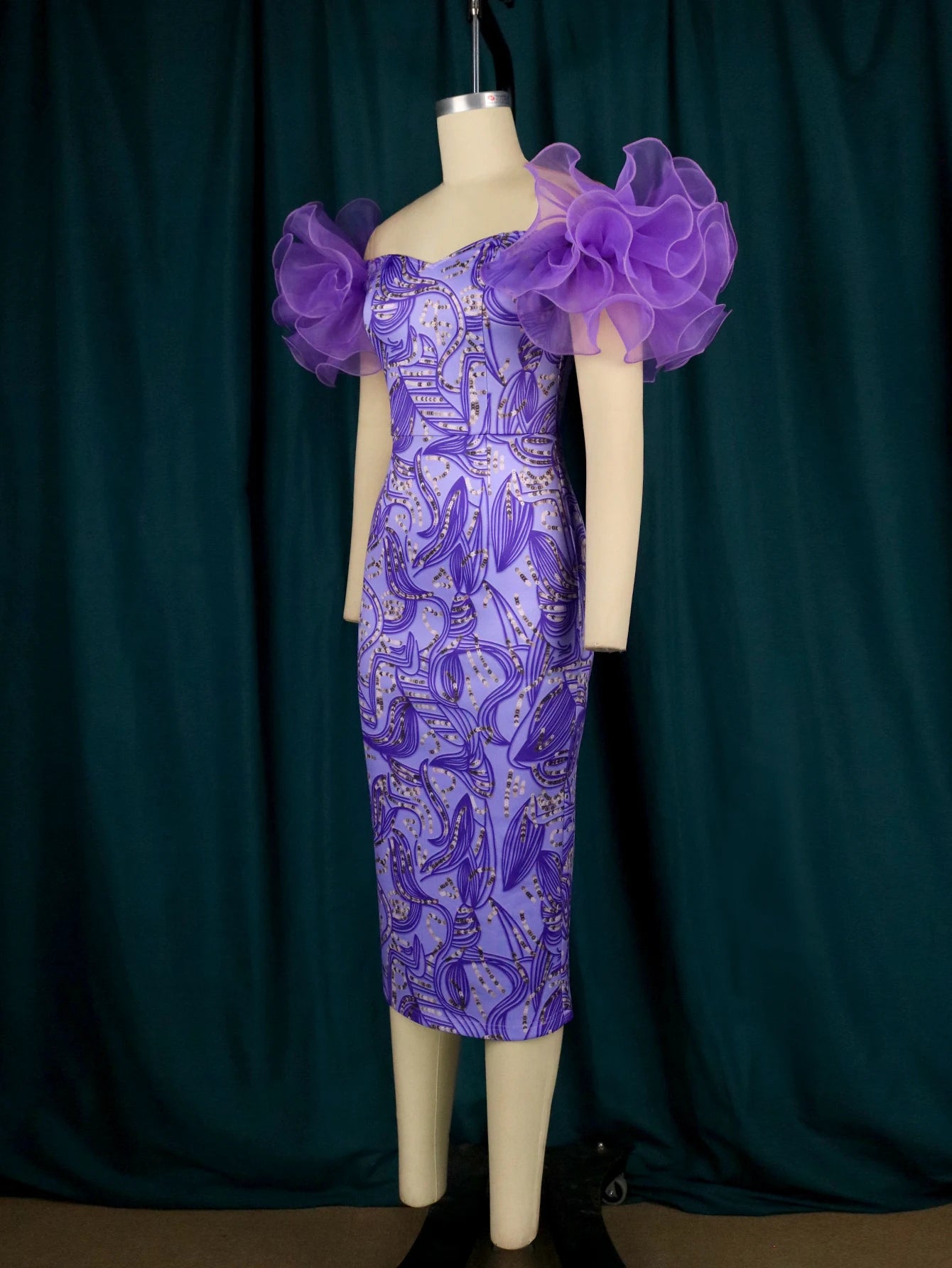 Woman's formal print dress by Showlu Fashion, off-shoulder tulle with floral and leaf contrast, perfect for African events and weddings.
