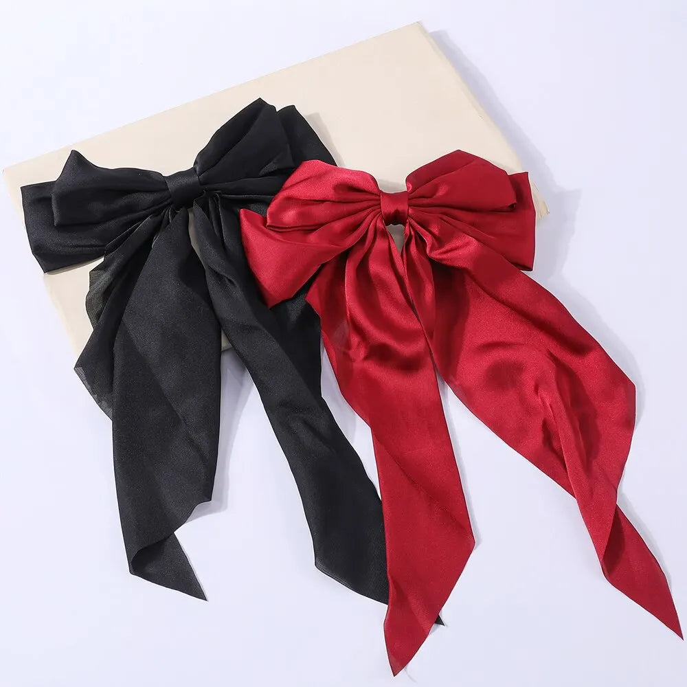 Set of two elegant satin bow hair clips for women and girls, stylish solid bowknot barrettes for ponytails and hair accessories.