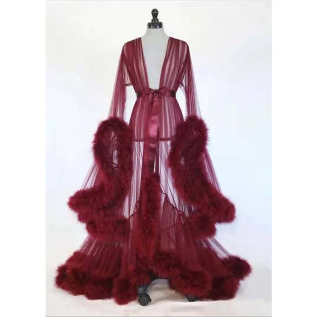 Deep V-neck lace maternity dress with tulle and feather details, long sleeves, perfect for photography or special occasions.