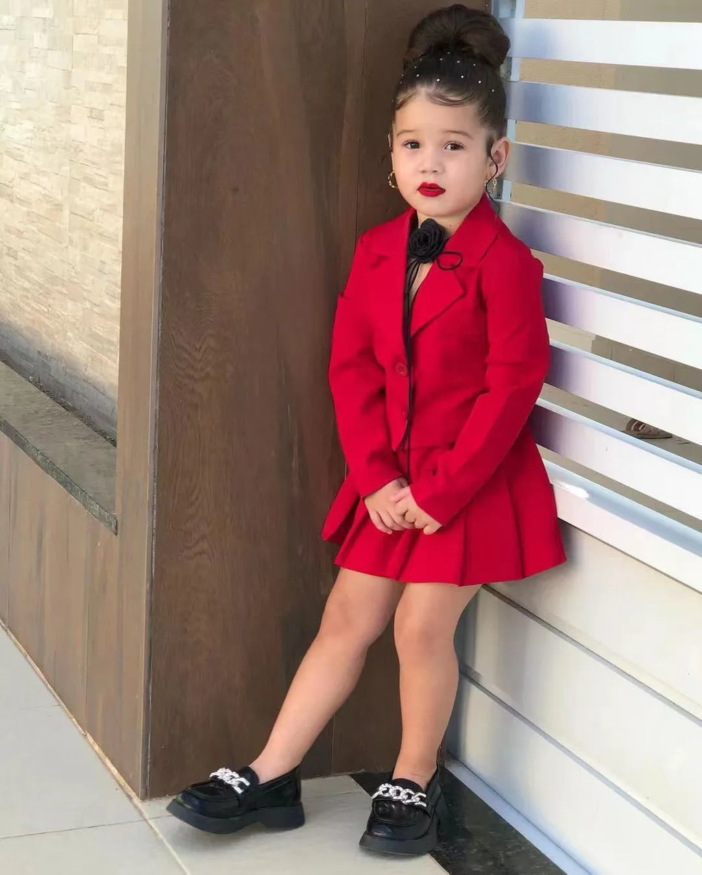Toddler girl in cotton jacket and skirt set by Showlu Fashion, size 2-8 years, smiling outdoors with playful pose.