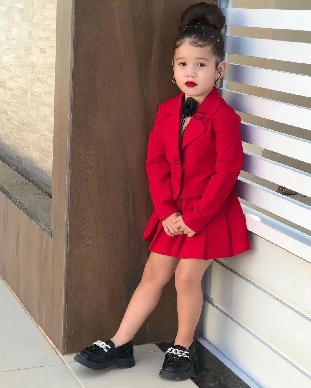 Toddler girl in cotton jacket and skirt set by Showlu Fashion, size 2-8 years, smiling outdoors with playful pose.
